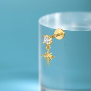 Macro shot of S925 sterling silver stamp on golden star tassel earring with crystal