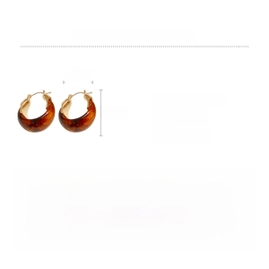 Detail showing amber resin U-shaped earrings with copper metal specs and 10.3g weight
