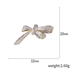 Sparkling gold bow brooch with micro-pave zircons, measuring 32mm by 20mm and 2.6g