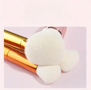 Detailed macro of soft synthetic bristles and metallic gradient handles on makeup brushes