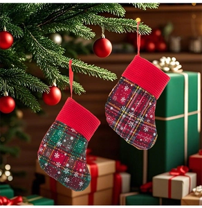 Mini plaid Christmas stocking cutlery holders hanging as festive ornaments on a tree branch