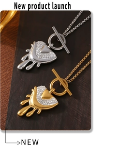 Close-up of heart pendant with melting design, rhinestones and OT buckle chain