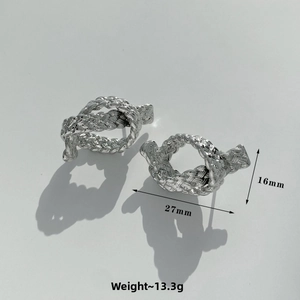 Macro view of silver knotted earrings showing woven texture and size dimensions