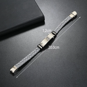 Macro view of grey braided leather bracelet with 20cm length and 1.2cm metal plate detail