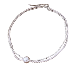 Elegant French double-layer pearl necklace with sparkling gemstone pendant on white background