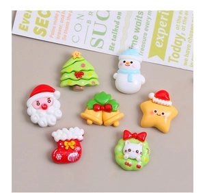 Detailed view of 7 resin Christmas charms featuring Santa, trees, and bells for DIY crafts