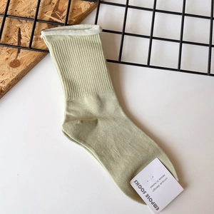 Pale green ribbed cotton socks with white rolled edges and Korean style design labels