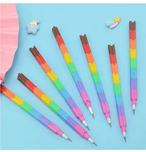 Close-up of rainbow stackable pencils with building block pieces on blue background