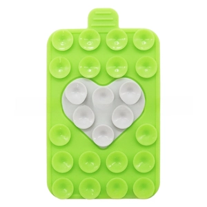 Detail of green silicone suction cup mat with white heart design and non-slip surface