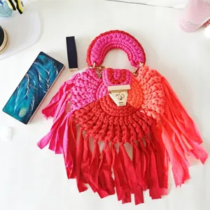Detail of handmade crochet semicircular fringe bag with colorful gradient and metal lock