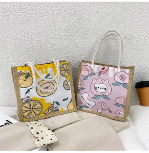 Detail of yellow and pink cartoon jute tote bags with soft cotton rope handles