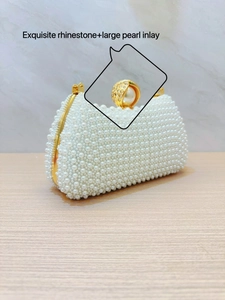 Exquisite rhinestone and large pearl inlay detail on white evening clutch bag frame