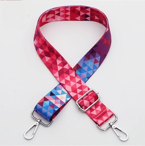 Detail of colorful geometric woven bag strap with adjustable silver metal buckle
