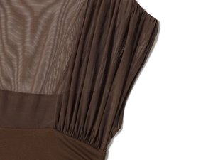 Detailed macro shot of dark brown mesh fabric with intricate pleats and textured stitching