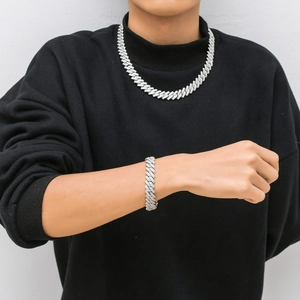 Model wearing a 14mm silver S925 moissanite cuban link chain necklace and bracelet set