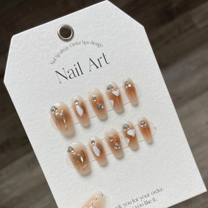 Handmade amber ballet nails with cream heart and gold glitter on white card