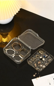 Detailed view of clear acrylic two-layer jewelry organizer for rings and watches