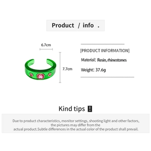 Detailed view of green resin open bracelet with pink rhinestones and product dimensions