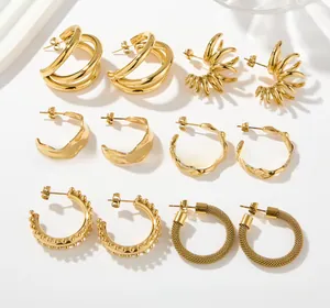 Detailed set of six gold titanium steel earrings featuring woven and polished textures