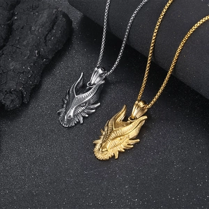 Detailed close-up of gold and silver dragon head pendants on sturdy box chains
