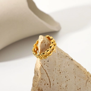 18K gold plated stainless steel interlocking chain ring on a minimalist stone base