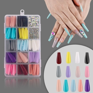 Detailed set of long stiletto false nails in multiple solid colors with rhinestone accents