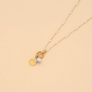 Detail of gold OT buckle necklace with white beads, seashell and purple gradient charms