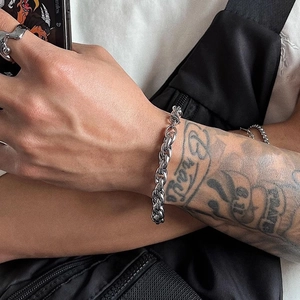 Silver Cuban link and twisted rope bracelet for men in hip hop style worn by model