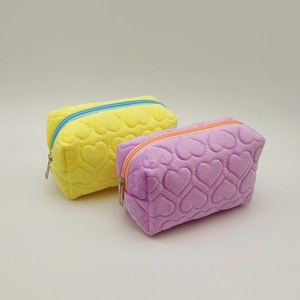 Quilted plush pencil cases in yellow and purple with embossed heart patterns
