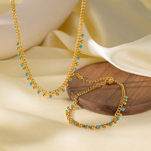 Titanium steel flattened chain jewelry set with turquoise beads on a silk background