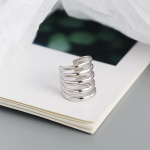Macro detail of silver multi-layer ear cuff showing polished metallic texture and finish