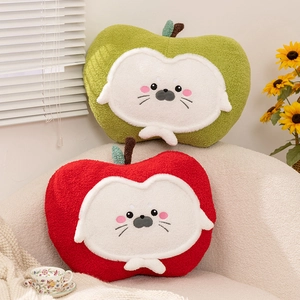 Cute seal apple plush pillows in red and green soft boucle fabric on a cozy sofa