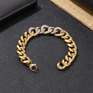 Detail of two-tone gold and silver Cuban chain bracelet with paved rhinestones