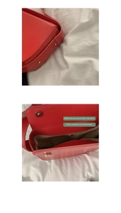 Detail view of red faux leather saddle bag with magnetic closure and inner zipper pocket