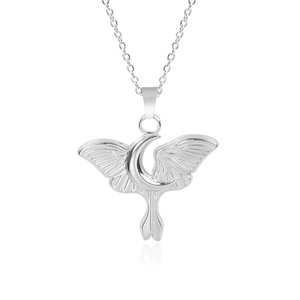 Detailed view of silver moon and butterfly wing pendant with necklace on white background