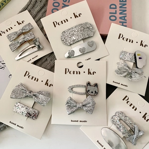 Silver sequin animal hair clips set featuring cute bow, heart and cat shapes on white card