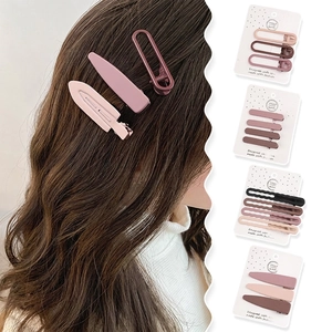 Brown matte duckbill hair clips set in Morandi tones shown on a model and card