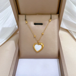 Gold titanium steel heart necklace with white shell inlay and sparkling crystal detail