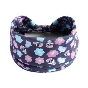 Macro detail of navy blue yoga headband featuring colorful skull and floral patterns