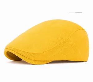 Close-up of a yellow corduroy beret hat showing soft texture and stitching details