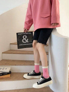 Pink striped socks with heart embroidery styled with casual denim and canvas shoes