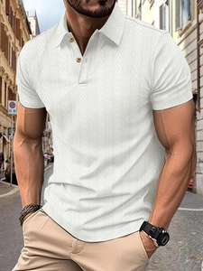 Close-up of white knitted polo shirt with textured vertical herringbone pattern fabric