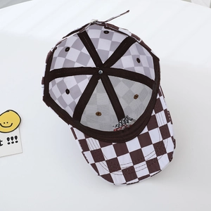Overhead view of checkerboard pattern kids baseball cap showing internal stitching and lining