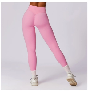 Detail of high-waist pink yoga leggings showing V-shaped back seam for butt-lifting effect