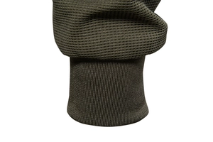 Macro shot of olive green jacket sleeve with waffle knit texture and ribbed elastic cuff