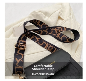 Detail of black faux crocodile leather crossbody bag with ethnic jacquard wide strap