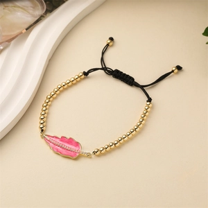 Adjustable gold bead bracelet with pink enamel leaf charm and zircon inlay