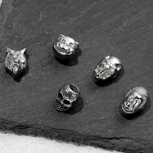 Silver stainless steel animal skull and buddha head spacer beads on dark stone