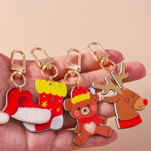 Cute Christmas acrylic keychain set featuring Santa hat, sock, bear, and reindeer designs