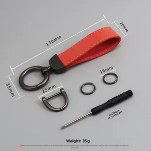 Detail view of red suede car keychain kit with measurements and metallic hardware